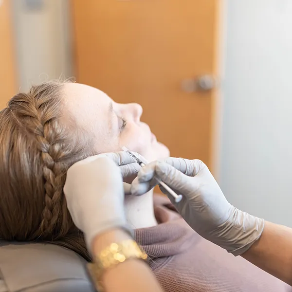 Kalon patient receiving an injection with eyes closed.